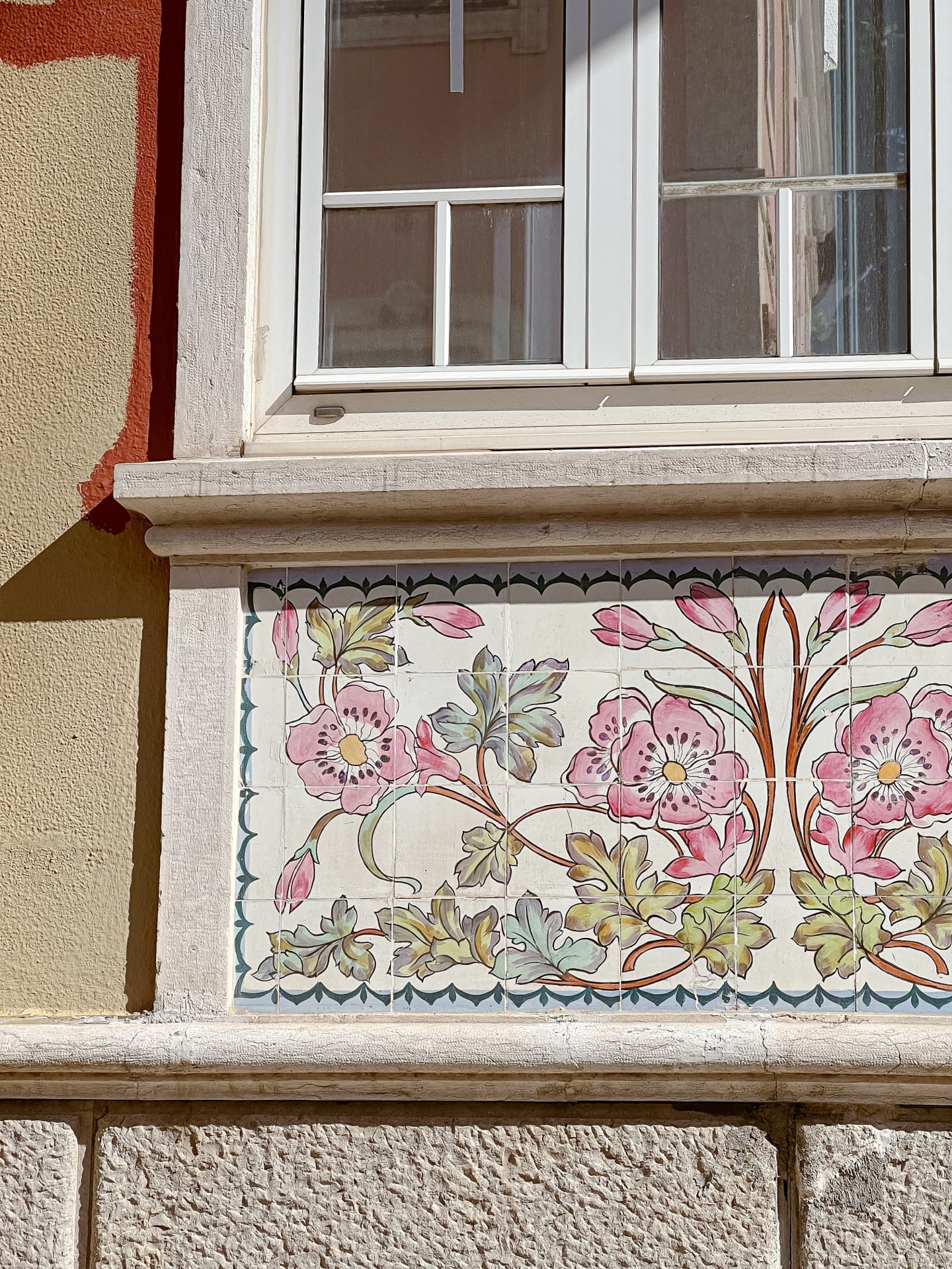 Floral azulejo tiles on a Lisbon building facade