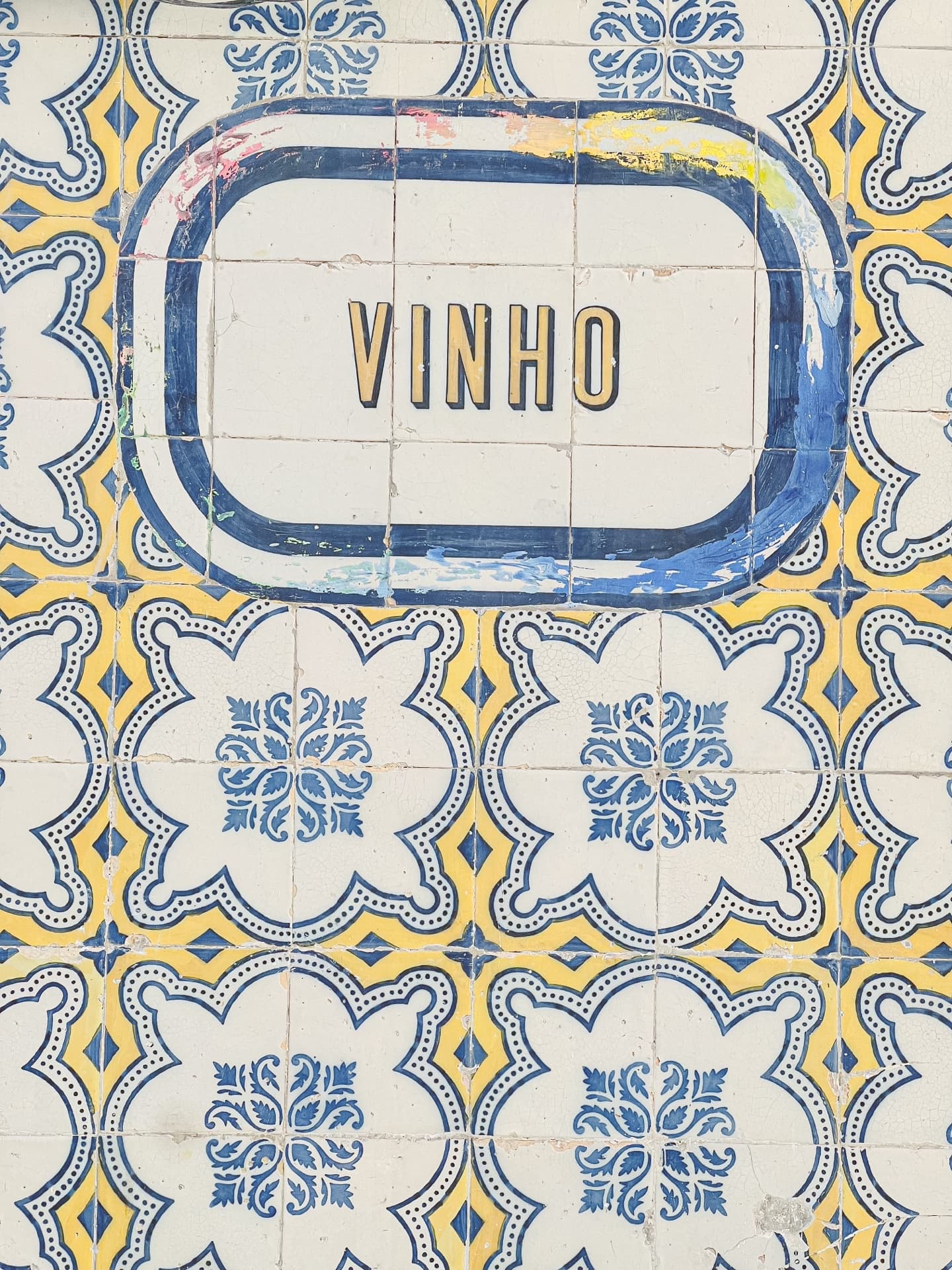 Vinho sign on traditional blue and yellow azulejo tiles